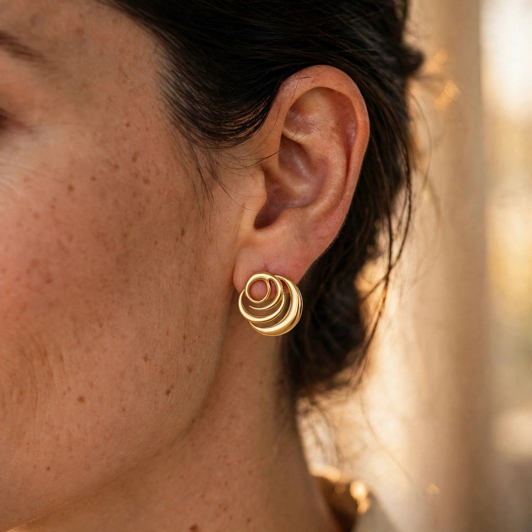 Close-up of the Roses Muse Signature Rose Earrings in 18k gold vermeil, worn