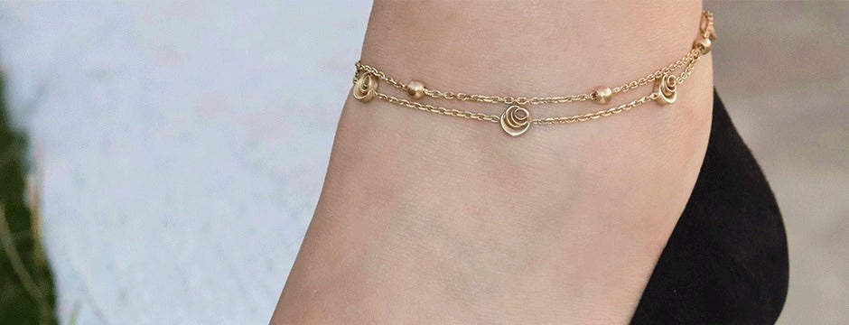 Signature Rose Anklet worn outdoors, double chain with rose discs, 18k gold vermeil
