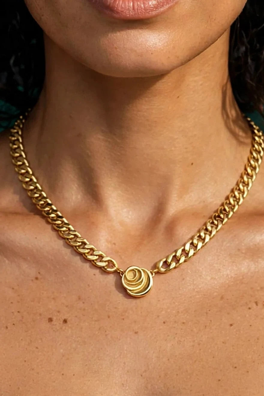 Close crop of the Signature Cuban link necklace with rose pendant worn by a model, mobile framing