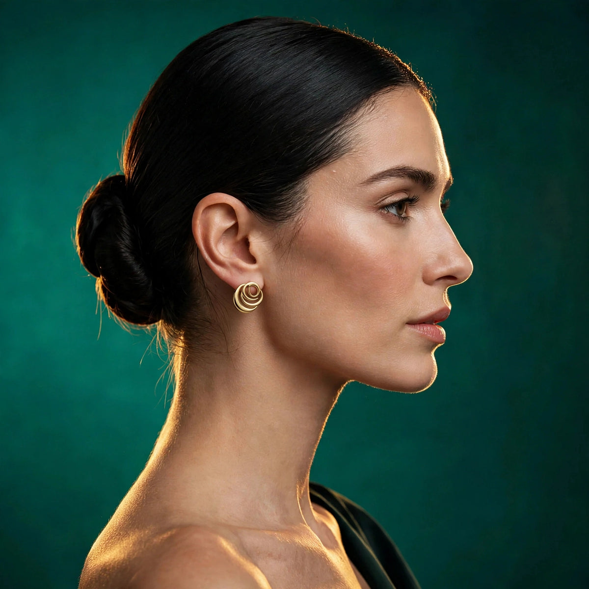 Model wearing Signature Rose Earrings in 18k gold vermeil against an emerald backdrop
